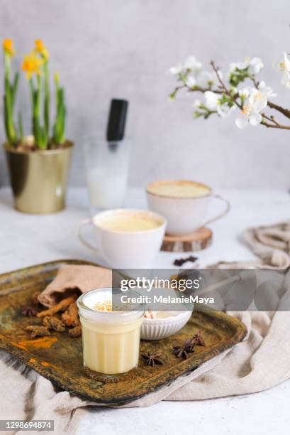 tumeric golden milk chai latte kurkuma tea with milk in spring - chai tea stock pictures, royalty-free photos & images