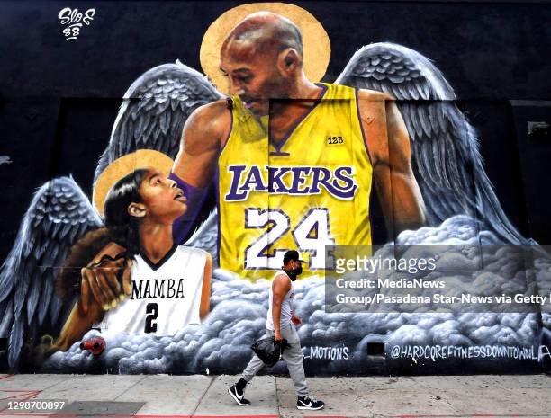 Man walks past a Kobe Bryant and Gigi mural on the side of the Hardcore Fitness Bootcamp as January 26 2020 is the Anniversary of the death of Kobe...