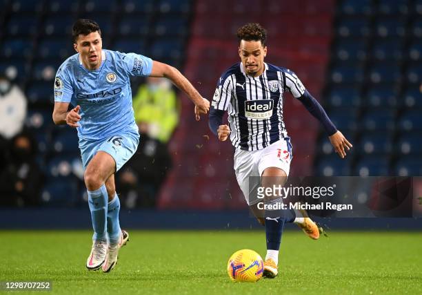 Matheus Pereira of West Bromwich Albion is challenged by Rodri of Manchester City during the Premier League match between West Bromwich Albion and...