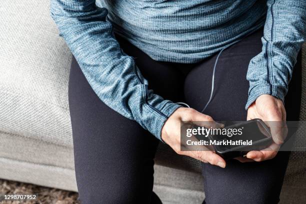 woman using insulin pump - insulin pump stock pictures, royalty-free photos & images