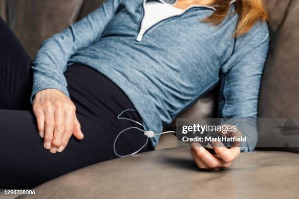 woman using insulin pump - insulin pump stock pictures, royalty-free photos & images