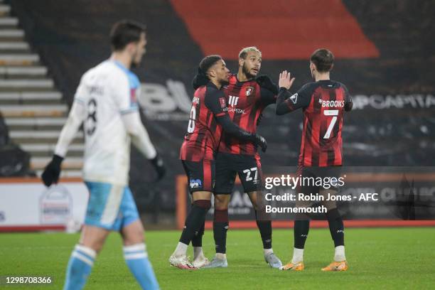 Joshua King of Bournemouth is congratulated by team-mates Arnaut Danjuma and Joshua King after he scores a goal to make it 2-1 during the Emirates FA...