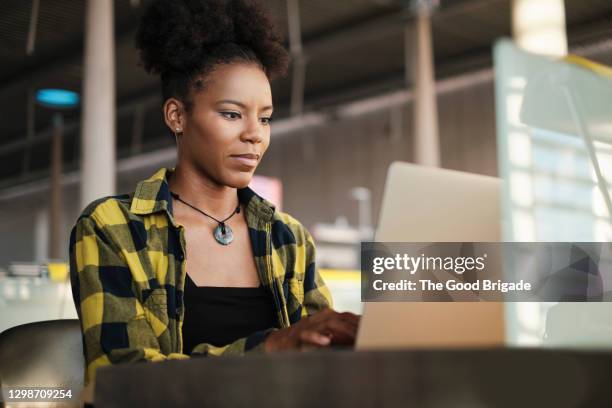 confident woman working on laptop computer in library - women studying stock pictures, royalty-free photos & images