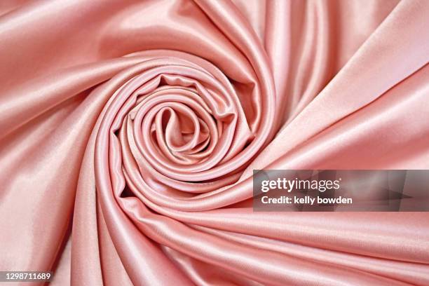 rose gold silk satin rose swirl fabric texture background - rose gold imagens e fotografias de stock