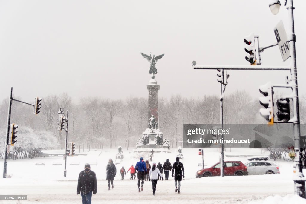 Montreal city park with people enjoying snow storm.