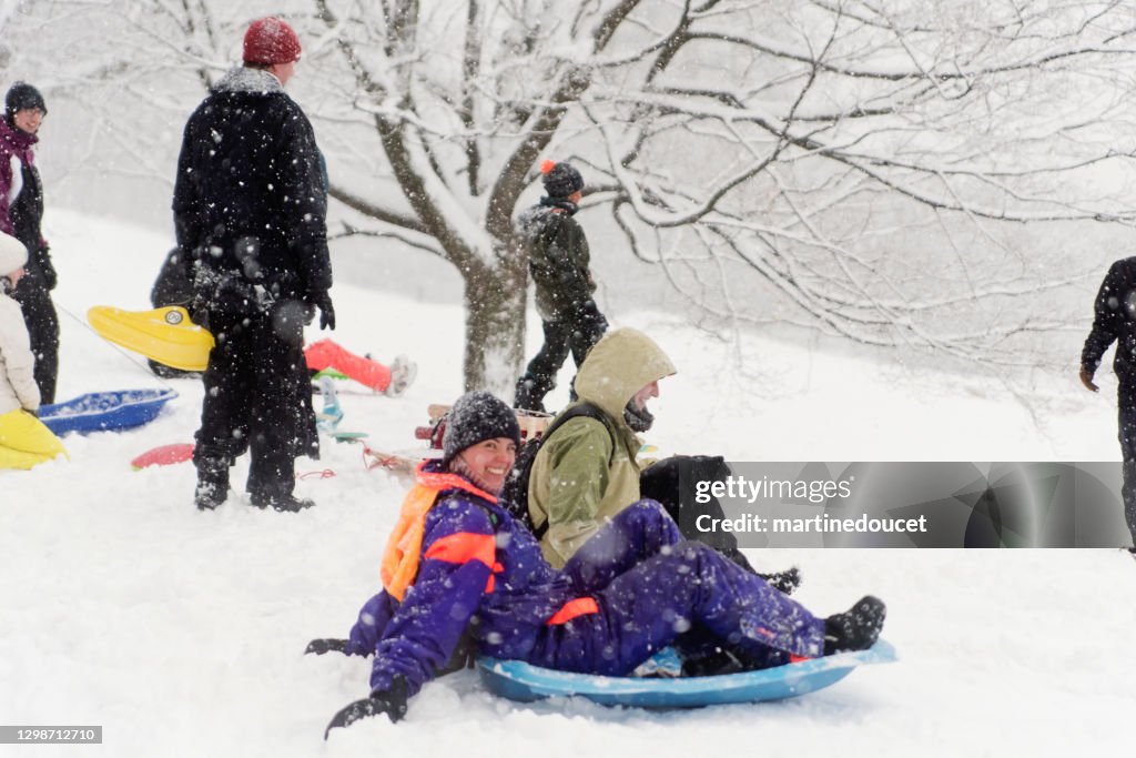 Montreal city park with people enjoying snow storm.