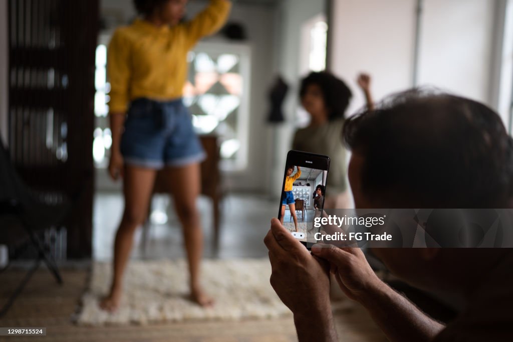 Family Using Filming Camera Father Filming On Smartphone Family Dancing At Home High-Res Stock ...