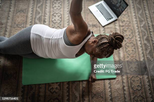 senior woman doing online exercise class with laptop at home - working on laptop in train top view stock pictures, royalty-free photos & images