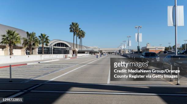 An empty crosswalk and drop-off for departing flights greets travelers at John Wayne Airport in Santa Ana, CA on Tuesday, January 26, 2021. Passenger...