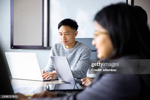 two asian colleagues working together - marketing technology stock pictures, royalty-free photos & images