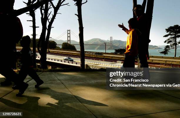 Visitors make their way through The Presidio for the 75th anniversary celebration of the Golden Gate Bridge along Crissy Field, on Sunday May 27 in...