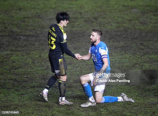 Mark Beevers of Peterborough United shakes hands with George Williams of Bristol Rovers during the Sky Bet League One match between Peterborough...