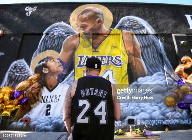 Fans stand in front of a mural painted in tribute to Kobe Bryant after his death one year ago on January 26, 2021 in Los Angeles, California.