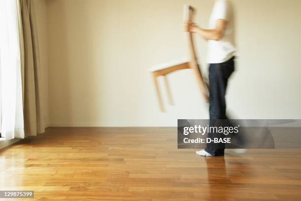 the man who carries a chair in a room - middle age imagens e fotografias de stock