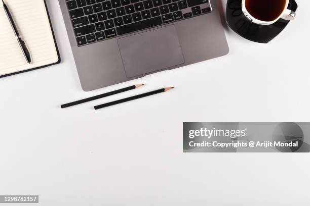 top view of white office desk table with cup of black tea, computer keyboard notepad, pen pen, pencil with copy space flat lay - office work flat lay stock pictures, royalty-free photos & images