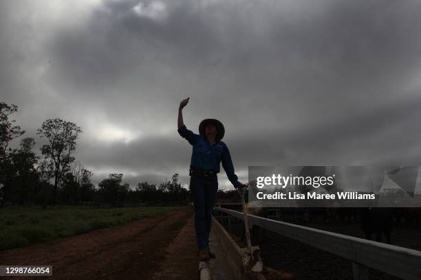 Molly Penfold reaches towards the sky in an attempt to get a mobile signal at 'Mamaree' on January 19, 2021 in Meandarra, Australia. COVID-19 and the...