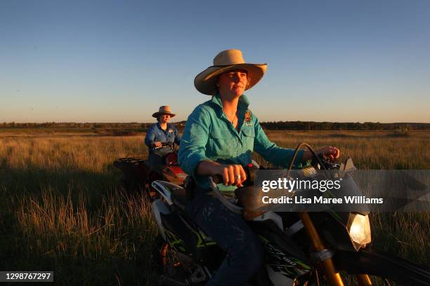 Sisters Matilda and Molly Penfold take a late afternoon ride through an open paddock at Old Bombine on January 19, 2021 in Meandarra, Australia....