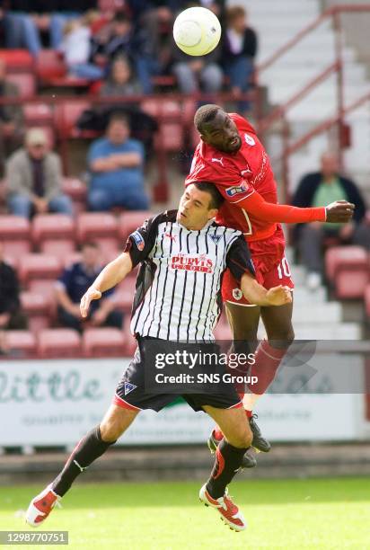 V RAITH ROVERS .EAST END PARK - DUNFERMLINE.Gregory Tade beats Dunfermline's Steven Bell to the ball