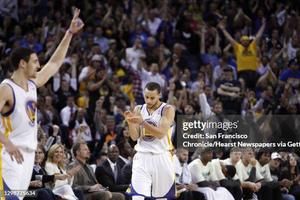 Stephen Curry reacts after hitting a three-point shot in the second half. The Golden State Warriors played the Minnesota Timberwolves at Oracle Arena...