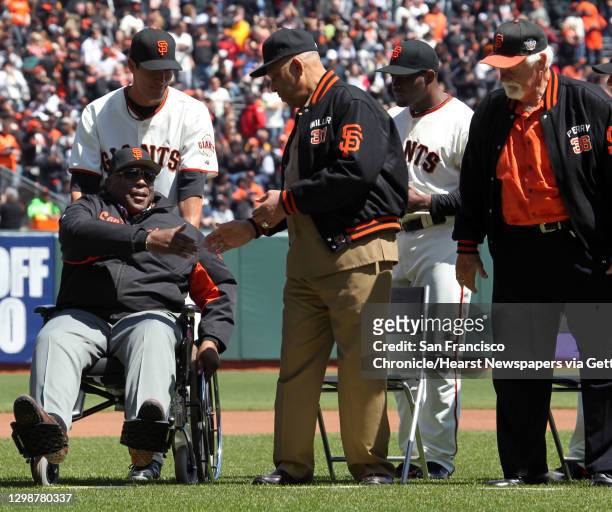 Willie Mc Covey, Orlando Cepeda, and Gaylord Perry, right, all members of the 1962 San Francisco Giants talk to one another during a pregame ceremony...