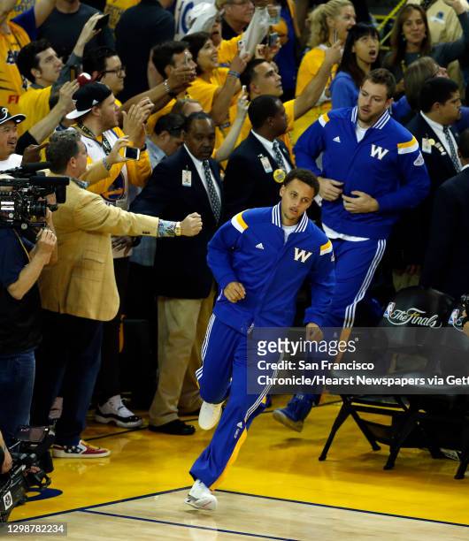 Golden State Warriors' Stephen Curry and David Lee lead team on to the court before playing Cleveland Cavaliers during Game 5 of NBA Finals at Oracle...