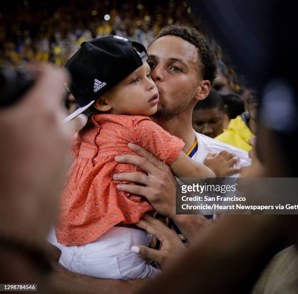 Golden State Warriors’ Stephen Curry kisses his daughter, Riley, after the Warrior's 104 to 90 victory over the Houston Rockets during Game 5 of the...