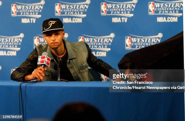 Golden State Warriors' Stephen Curry speaks to the media as his daughter Riley plays after Warriors' 104-90 win over Houston Rockets in Game 5 of NBA...