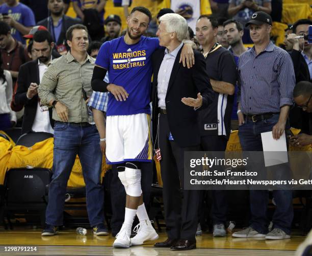 Stephen Curry chats with his college coach from Davidson, Bob McKillop, before the Golden State Warriors played the Cleveland Cavaliers in Game 1 of...