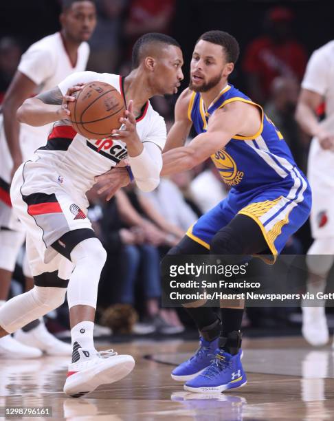 Golden State Warriors' Stephen Curry against Portland Trail Blazers' Damian Lillard in 1st quarter in Game 4 of NBA Western Conference 1st Round...
