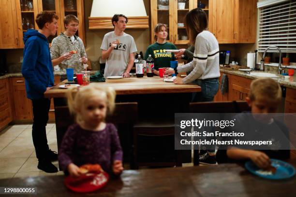 Lance Lighthall eats pizza with friends just six days after his house burned down and home was decimated by the Camp Fire in Chico, California, on...