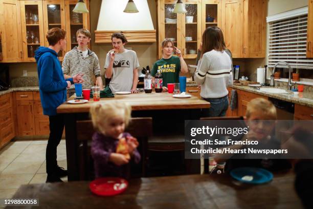 Lance Lighthall eats pizza with friends just six days after his house burned down and home was decimated by the Camp Fire in Chico, California, on...