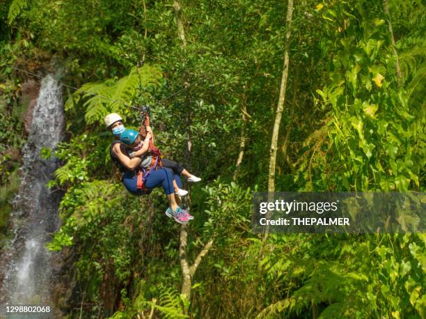 woman and her three years old girl on a zip line in costa rica - costa rica zipline stock pictures, royalty-free photos & images