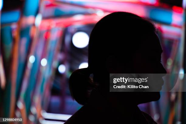 asian woman in silhouette against neon light - anticipation face stock pictures, royalty-free photos & images