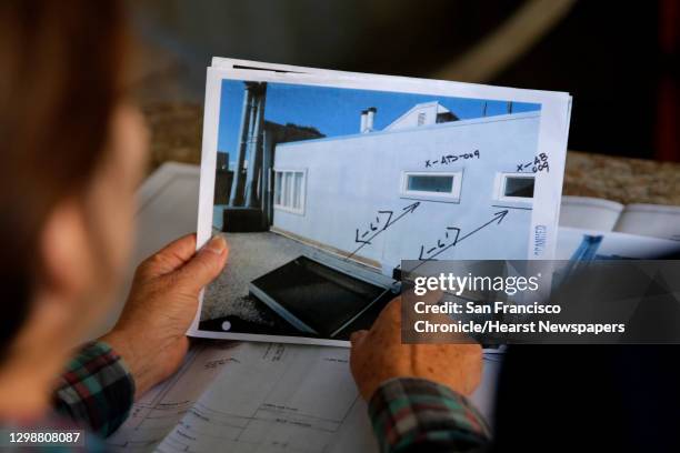 Teresa Votruba explains a permitting question to Carly Grob, a planner with the city, during a mobile workshop put on by the city's planning...