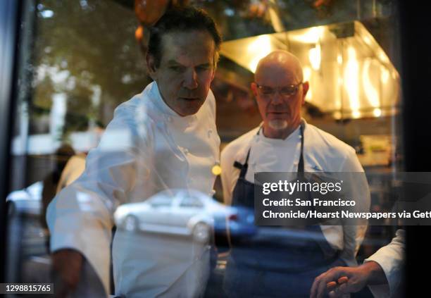 The Thomas Keller, left, checks dishes with one cook in the kitchen of Quince on Sunday, July 29, 2012 in San Francisco, Calif.