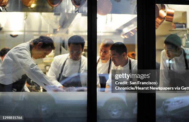 Chef Thomas Keller, right, works with chef Corey Lee, second from right and other cooks in the kitchen of Quince on Sunday, July 29, 2012 in San...