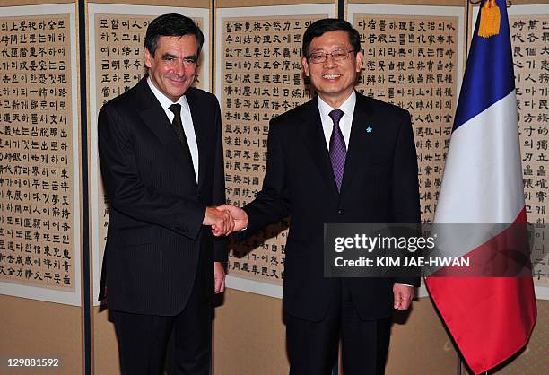 French Prime Minister Francois Fillon shakes hands with his South Korean counterpart Kim Hwang-Sik before their lunch in Seoul on October 21, 2011....