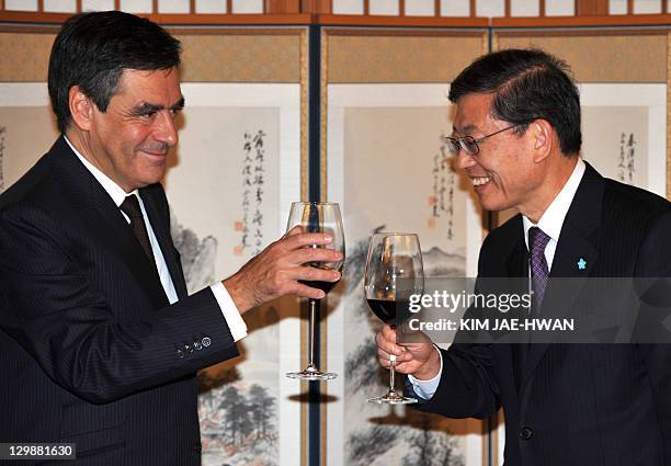 French Prime Minister Francois Fillon toasts with his South Korean counterpart Kim Hwang-Sik during their lunch in Seoul on October 21, 2011. Fillon,...