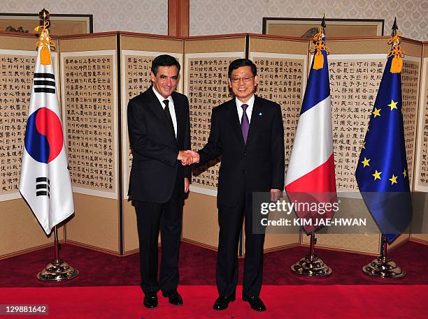 French Prime Minister Francois Fillon shakes hands with his South Korean counterpart Kim Hwang-Sik before their lunch in Seoul on October 21, 2011....