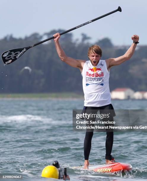 Casper Steinfath of Denmark exults after winning the Red Bull Heavy Water stand-up paddleboard race in San Francisco, Calif. On Friday Oct. 20, 2017....