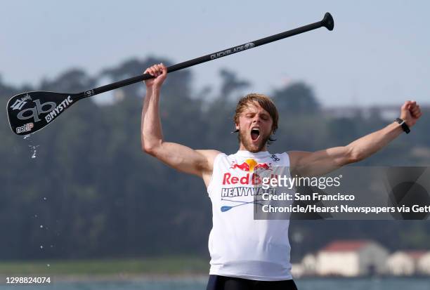 Casper Steinfath of Denmark exults after winning the Red Bull Heavy Water stand-up paddleboard race in San Francisco, Calif. On Friday Oct. 20, 2017....