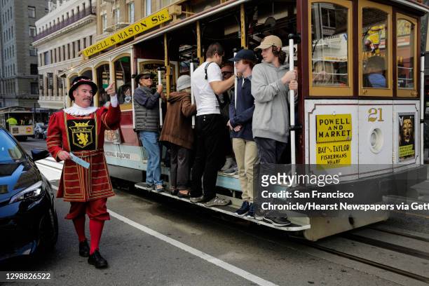 Sir Francis Drake hotel doorman Tom Sweeney greets cable car riders while working on Powell Street in San Francisco, California, on Thursday, April...