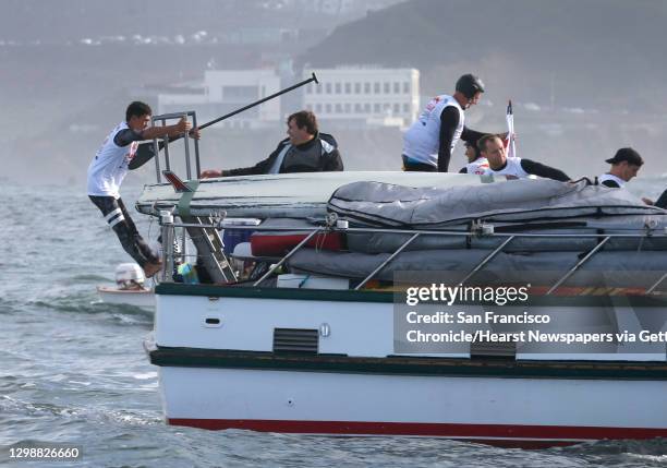 Competitors in the Red Bull Heavy Water stand-up paddleboard race prepare to jump into the ocean near the Cliff House in San Francisco, Calif. On...