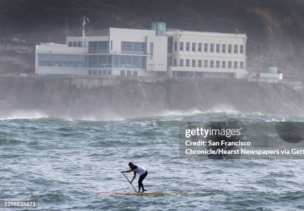 First place finisher Casper Steinfath paddles past the Cliff House during the Red Bull Heavy Water stand-up paddleboard race in San Francisco, Calif....