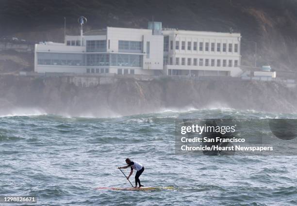 First place finisher Casper Steinfath paddles past the Cliff House during the Red Bull Heavy Water stand-up paddleboard race in San Francisco, Calif....