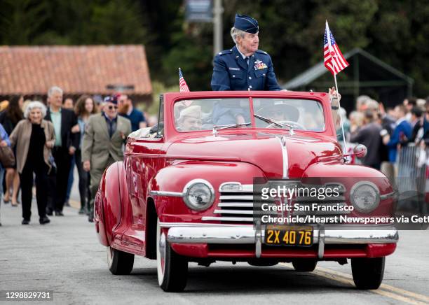 Vietnam Veteran John Farrell rides in a vintage car during a parade march to the annual Memorial Day observance held at the Presidio Cemetery in San...