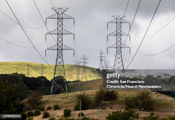High-voltage power transmission lines owned by PG&E are seen stretched across a neighborhood in western San Ramon, Calif. Friday, May 17, 2019.