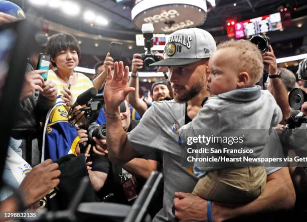 Golden State Warriors' Stephen Curry with son, Canon, after 119-117 overtime win over Portland Trail Blazers' in NBA Western Conference Finals' Game...