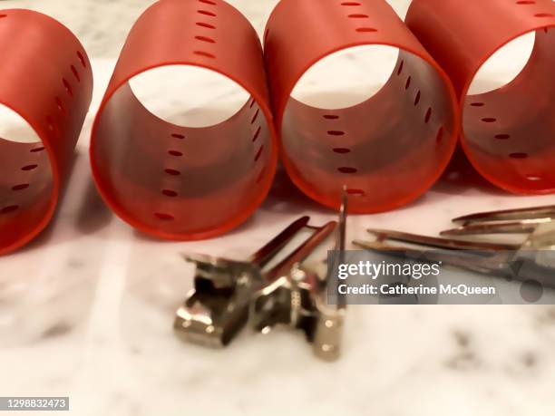 red plastic hair rollers & silver hair clips - black hair salon stock pictures, royalty-free photos & images