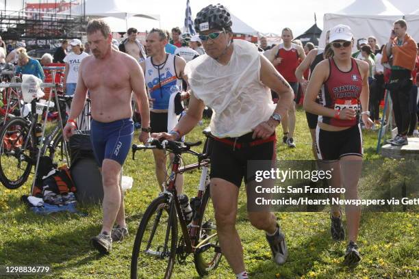 Racing the clock participants rush to put on their gear for the second part of their triathlon in the Escape from Alcatraz Triathlon in San Francisco...